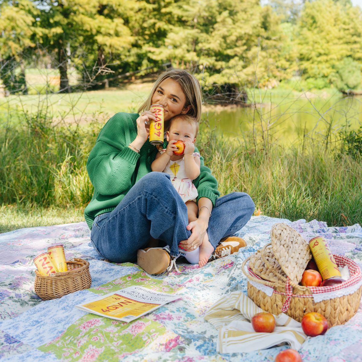 Sadie Robertson Huff on a picnic blanket with her daughter, sipping a 4GVN Half-Caff
